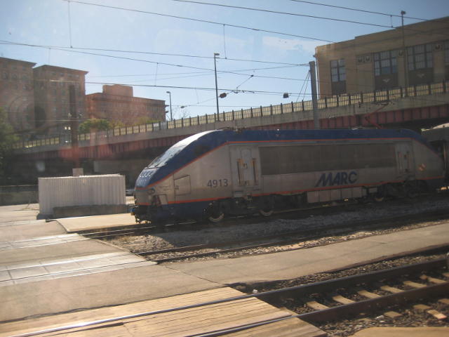 An electric loco hauls a double-deck suburban train out of Baltimore, Maryland