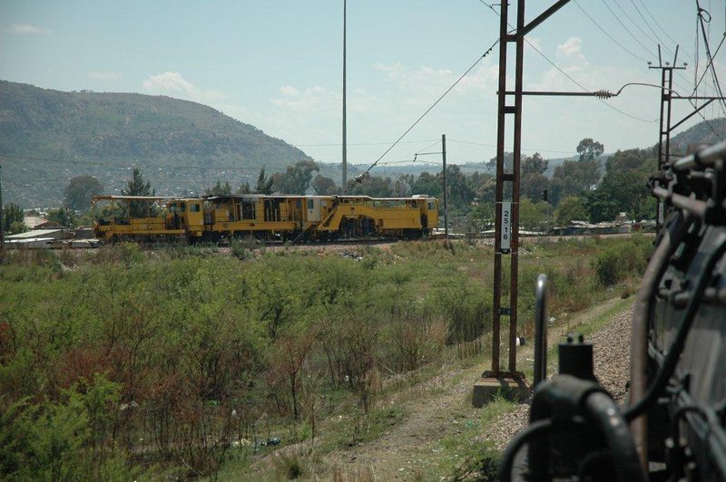 Approaching Pienaarspoort area we come to the junction with the line from Pyramid South to Sentra Rand. This massive track machine was at work whilst the 19D was en route to Cullinan