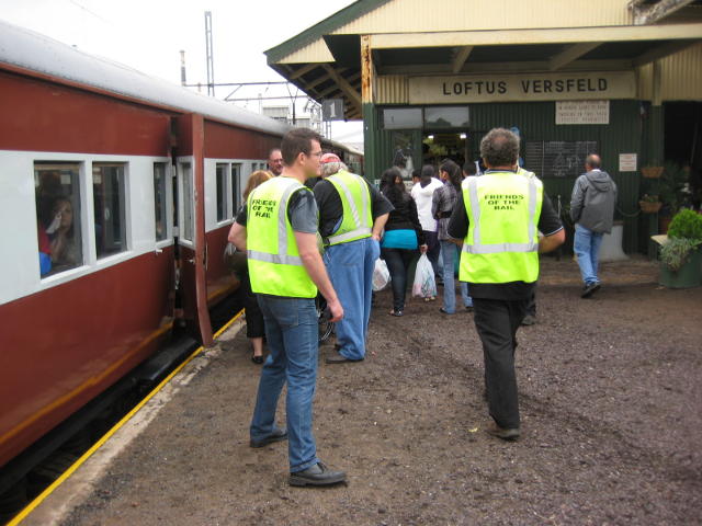 Train Manager Henry (left foreground) tries to shepherd his coach controllers and passengers (not necessarily in that order!) onto the train