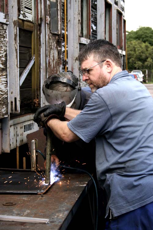 John A assists welder John D