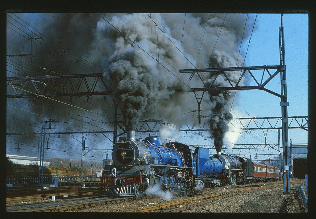 A magnificent sight as the Blou Bull 19D 2779 and 15CA 2056 leave Pretoria on a schools special around the complex. These trains would often operate in the week by the SAR for schools as charters.