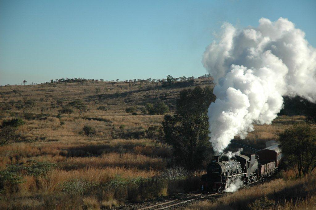 Train and country side. The diminutive class 24 handles its mixed train from Cullinan with much gusto. The crisp winter air makes for some beautiful exhaust.