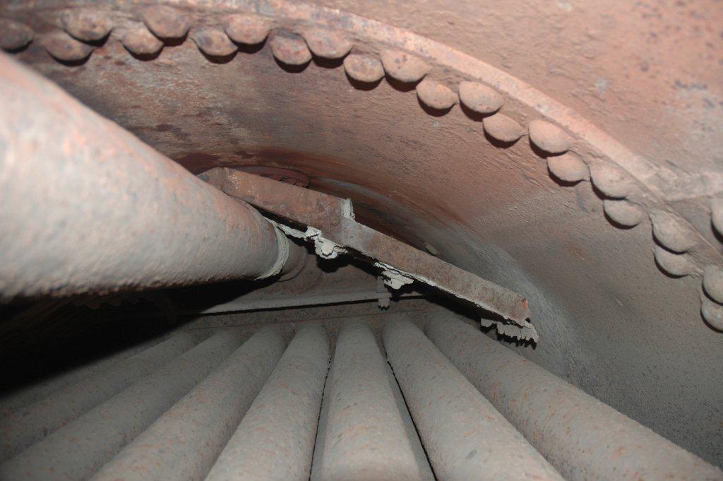 The tubes convey the heat generated in the firebox to the smokebox, while at the same time heating the water around them, much as an electric element in a kettle, thus generating steam which the locomotive uses to get in motion. The main pipe on the left upper is the main steam pipe, into which the steam collected in the dome, will travel to the superheater and onwards to the steam chest. Directly in front can be seen what are known as Baffle Plates. These plates are perforated and are situated directly under the clack box which enables the water to be fed into the boiler via the injectors. The cooler water entering is thus broken up and will heat faster and not create a huge loss of temperature.