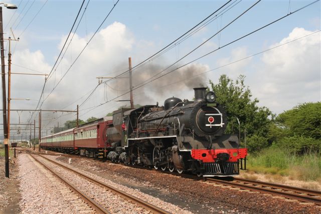 ABSA Charter- 3664 looking very smart hits the level crossing at Bon Accord