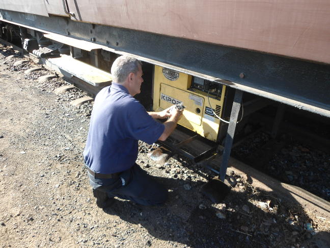 Steve works on the generator for the lounge car