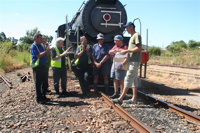 FOTR's Chris Janisch receives the cheque from Jean Dulez. Looking on from left are Steve Smith, Manie Neethling, Steve Appleton, John Ashworth and Robert Dadford.