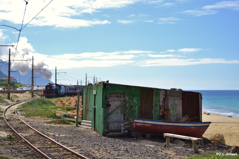 With Simons Town station just a few hundred meters ahead, 879 slowly makes her way past a local fisherman's shack.