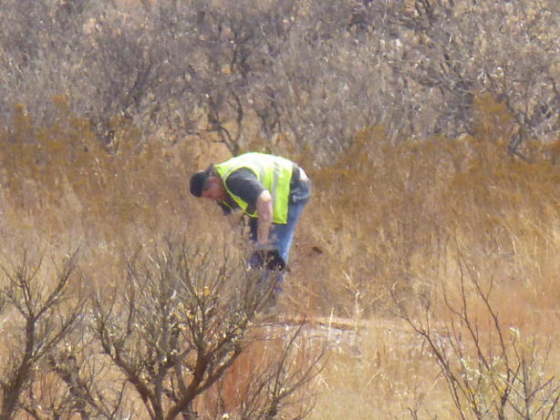 He shovels sand off the rails