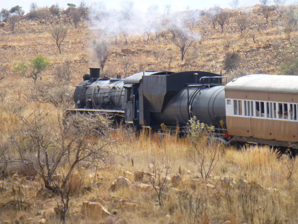 The train slows to a halt at the new level crossing just before Cullinan