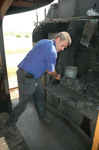 Into the swing of things. Trainee Fireman Steve Smith does a south paw firing turn on the 24 class. Steve is undergoing Train Assistant final course and this was part of his practical efforts. Most of the coal we see here was thrown out the window!!