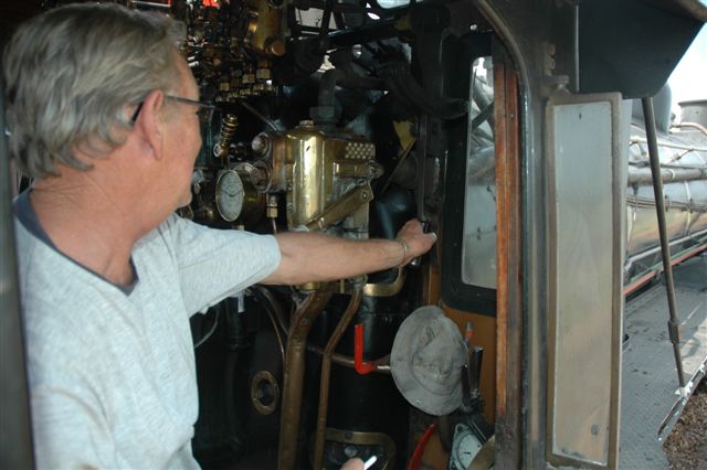 Driver Cliff Petzer eases the regulator of the 24 class locomotive, as she enters the downgrades into Pyramid South yard on the FOTR Tshwane Xplorer