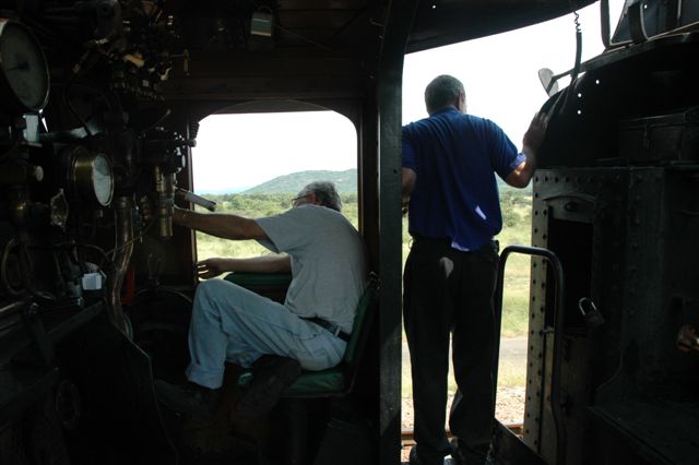 The open countryside looms in the background, as driver Cliff Petzer and trainee Fireman Steve Smith take a look in the hope of seing some game.