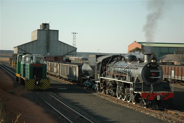 Industrial action at the Rooiwal Power Station. The class 24 has brought in a load from the exchange yard at Pyramid station, into the yard at Rooiwal, and now waits for the power station's motive power to pass, before heading back to the main line once more. This operation at the power station is 24/7 and features some very interesting diesel shunters. The steam side is only here for a safari operation