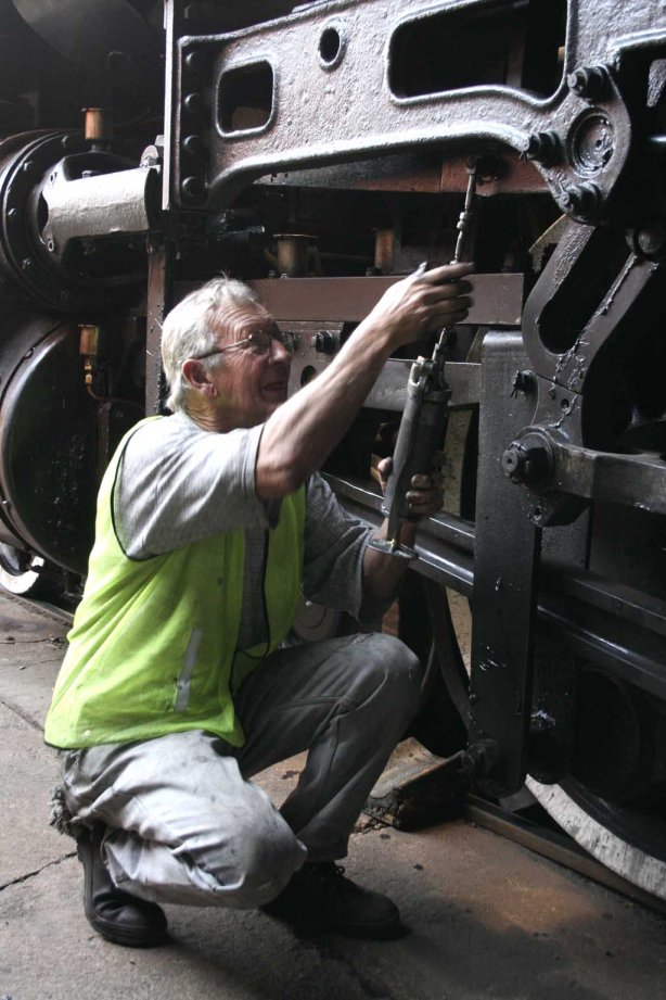 Driver Cliff greases his loco<br /><br />Photo by Miemie Wolmarans August 2007