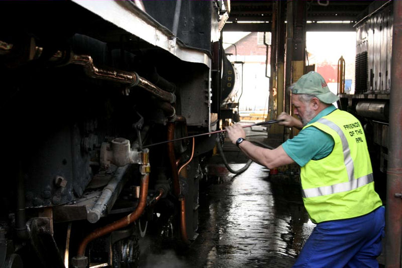 Kobus wields the ash pan pricker while cleaning 2650's fire in Witbank<br /><br />Photo by Miemie Wolmarans August 2007