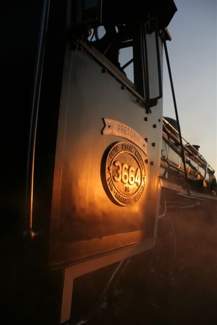 Gentle steam whisps lazily into the picture as 3664 basks in the evening sun.