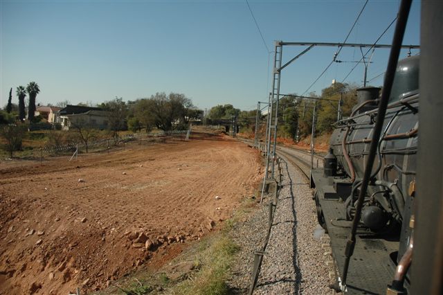 Viewed from the cab of 24 class 3664, the earthworks just out of Pretoria main station for the future Gautrain can clearly be seen. Some day there may still be a race between the two forms of motive power!