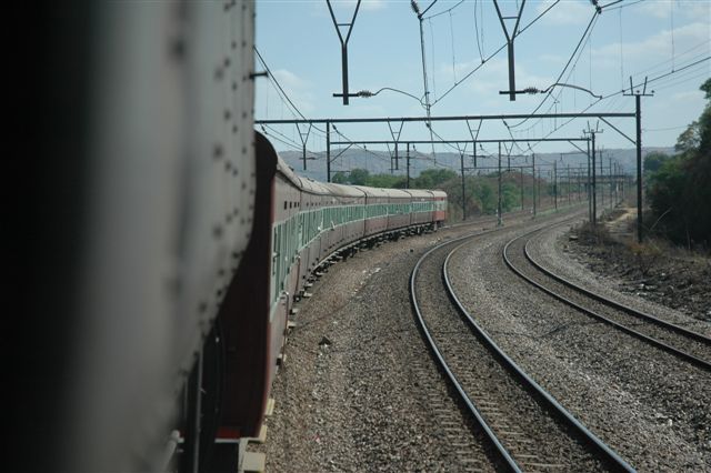 Train trailing safely behind and the hills of Pretoria look on in the background. Wonderboompoort approaches