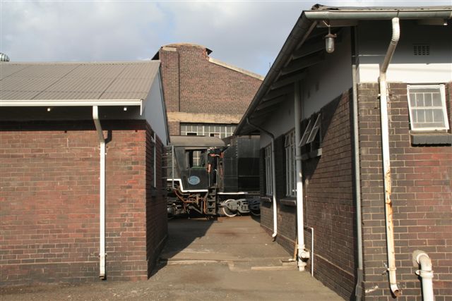 No 2650 is caught backing down in between the shed buildings.