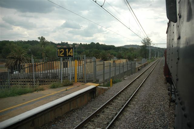 Completed bridge works at Loftus Verseveld station, ready for Gautrain tracks. The Tshwane Xplorer, and 19D 2650, go rolling by