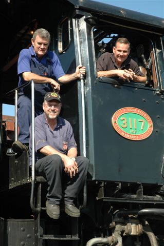 Men making history. Newly qualified Fireman Steve Smith looks over John Ashworth, Fireman, and Driver Frik Boshoff in his position