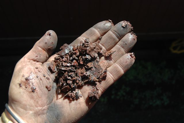 Some of the scale that gets dislodged by the jets of high pressure water. This is usually an accumulation of water treatment, salts and scale that will form. Remember, there are different qualities of water and not all is good for boilers, especially bore hole water, if it is not treated beforehand. Railways, in steam days, used to have water softening plants at many depots and areas along the line at water stops.