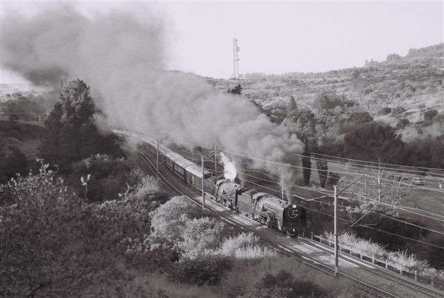FOTR and Reefsteamers provide the motive power for Rovos Rail's Cape Town train, seen climbing up the Fountains Valley towards Johannesburg. The two 15F's make a grand sight as they blast away