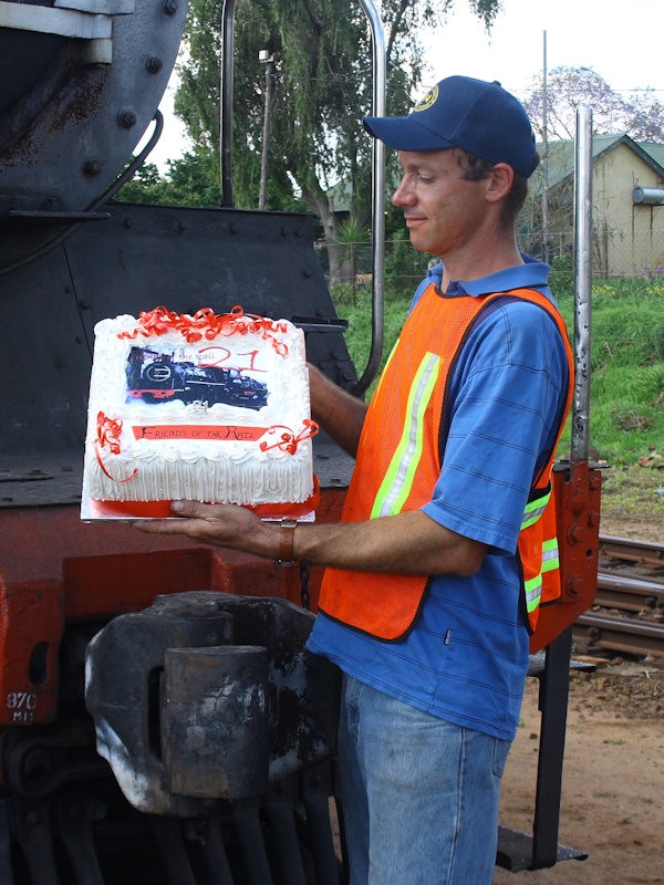 Chris J admires the cake....or is he thinking back to his 21st and remembering the girls who jumped out of the cake on that occasion???<br /><br />03/11/07 K R Wilson-Smith