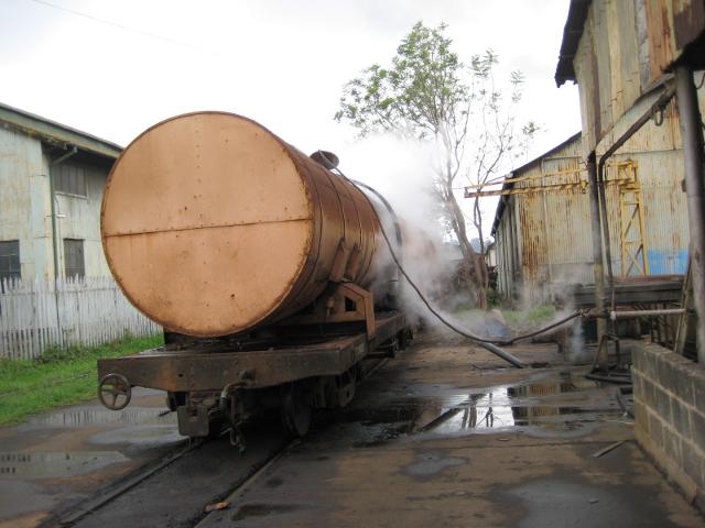 A tank wagon wreathed in steam