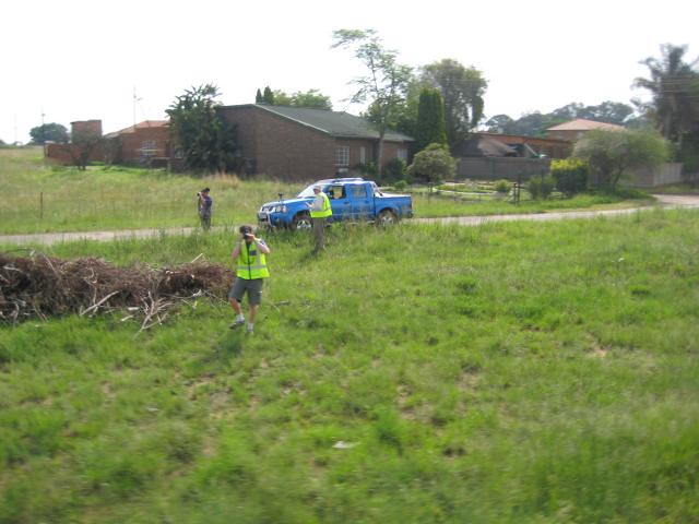 Kevin, Linda and Mark doing something in a field