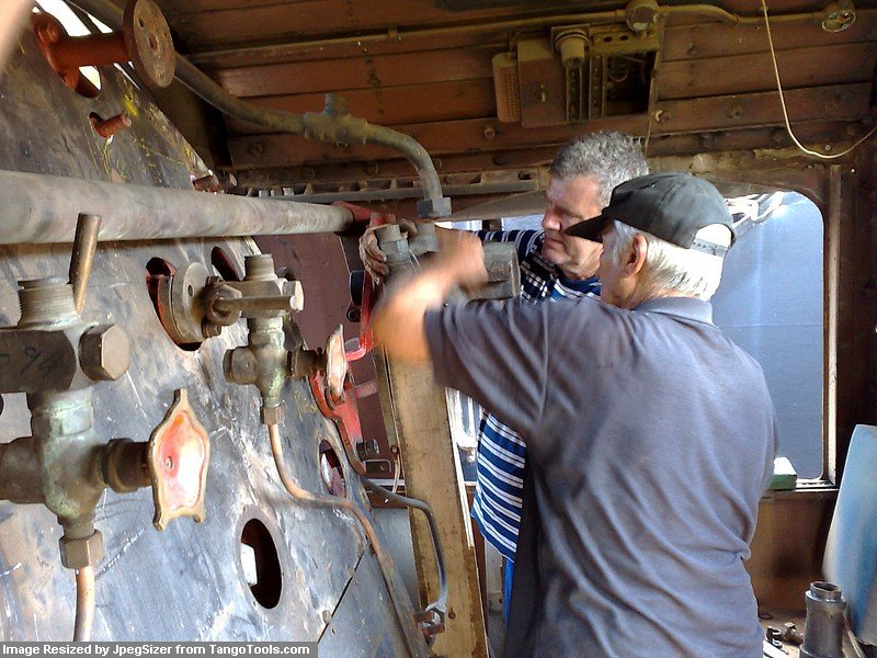 Steve helps John with the ejector mounting.